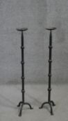 A pair of Gothic style cast iron tripod leg floor standing pricket candlesticks. H.91 W.21 cm