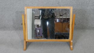A Herbert Gibbs oak swing mirror, stamped to underside. H.52 W.64 D.25CM