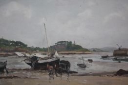 A framed oil on canvas of fishing boats on the shore. Indistinctly signed. H.43 W.52cm.