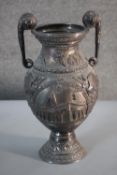 A large Victorian white metal repousse decoration twin handled commemorative cup. One side decorated