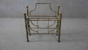 A vintage gilt metal magazine rack with gilt wood finials. H.57 W.47 D.20cm.