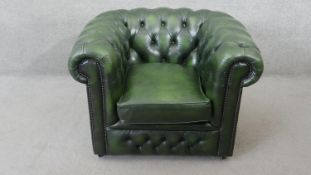 A Chesterfield armchair in deep buttoned studded leather upholstery.
