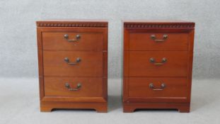 A pair of three drawer bedside chests on block supports. H.68 W.50 D.48 cm