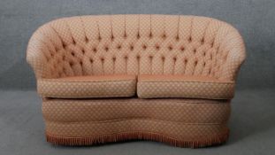 A 19th century style two seater sofa in deep buttoned geometric design upholstery. H.78 W.140 D.75CM