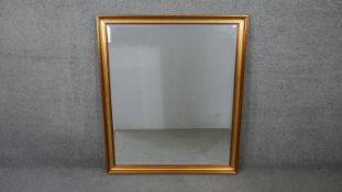 A large 20th century gilt framed wall mirror with bevelled glass. H.102 W.86cm