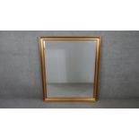 A large 20th century gilt framed wall mirror with bevelled glass. H.102 W.86cm