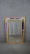 A glazed cushion mirror in beaded gilt frame. H.107 D.76CM