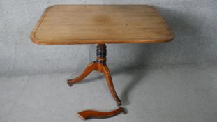 A Georgian mahogany and ebony strung tilt top table with ring turned pedestal on swept tripod