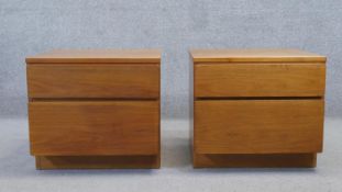 A pair of vintage teak bedside cabinets each fitted with two drawers on plinth base. H.51 W.56 D.