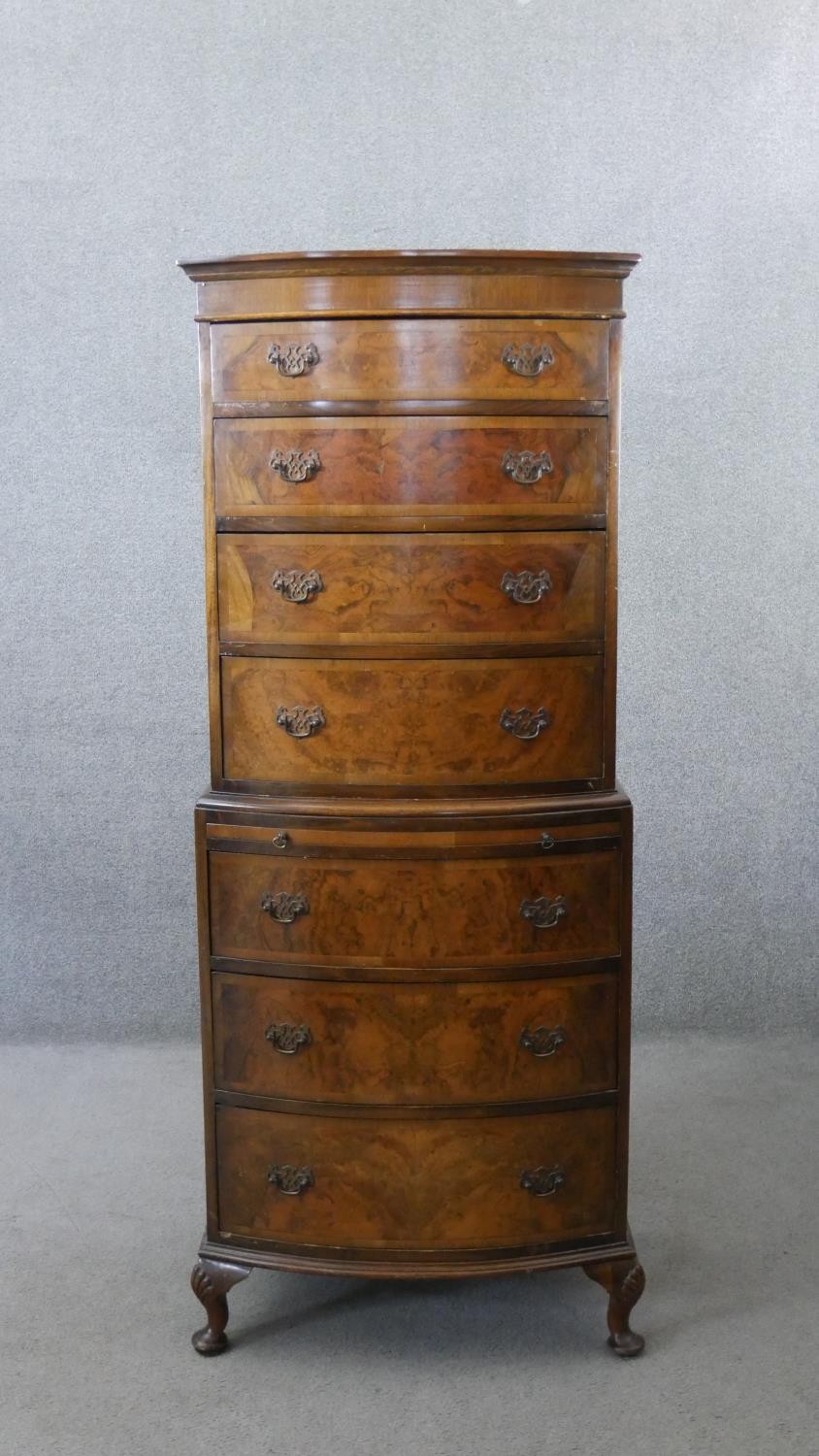 A Georgian style burr walnut and crossbanded bow fronted tallboy chest of four drawers above four