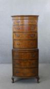 A Georgian style burr walnut and crossbanded bow fronted tallboy chest of four drawers above four