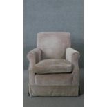 A contemporary armchair in piped velour upholstery.