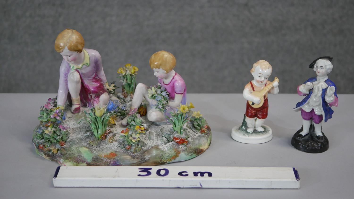 A Crown Staffordshire porcelain hand painted figure group by T.M. Bayley of children picking flowers - Image 2 of 8