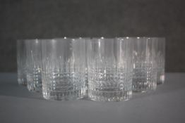 A set of nine Baccarat Nancy hand cut crystal small whisky glasses with abstract square design.