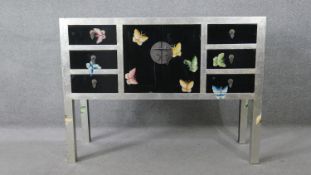 A Chinese lacquered side cabinet with hand painted butterfly decoration. H.90 W.120 D.40CM