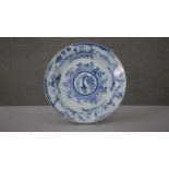 A large Kangxi blue and white hand painted porcelain charger. Decorated with temples and pagodas