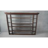 A Georgian country oak plate rack with dentil carved cornice above open shelves. H.125 W.166 D.15cm.