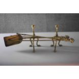 A pair of Victorian brass fire dogs with lion paw feet along with brass fire irons. (5 pcs) 68cm(