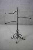 A Victorian style cast iron revolving towel rail with scrolling design base. H.102 W.106 D.40 cm.