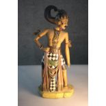 A 20th century west Javanese carved and painted figure of a warrior. H.51 W,20 D.14cm.