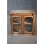A 19th century pine hanging cabinet with glazed arched panel doors. H.63 W.64 D.26 cm.