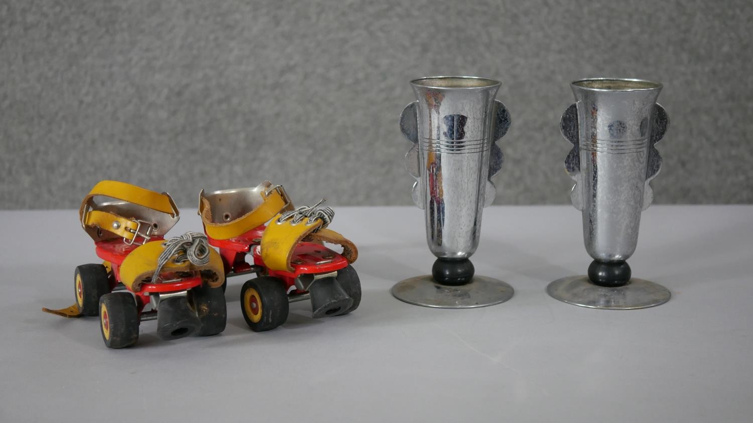 A pair of Art Deco chromed and bakelite goblets along with a pair of vintage tinplate childrens