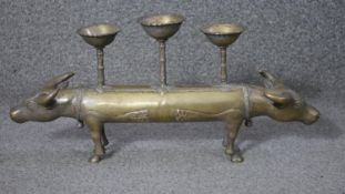 An Indian Buddhist 20th century brass double headed sacred cow three branch candle holder. H.20 W.45