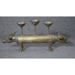 An Indian Buddhist 20th century brass double headed sacred cow three branch candle holder. H.20 W.45