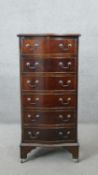 A Georgian style mahogany serpentine fronted tall chest of six drawers on shaped bracket feet. H.100