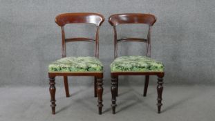 A pair of early Victorian mahogany bar back dining chairs on turned tapering supports.