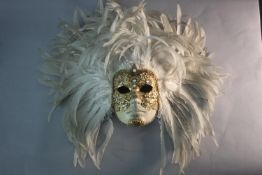 A bespoke Venetian carnival mask, with gilded brocade and white cockerall's feather headdress. H.