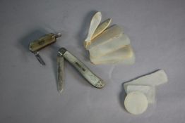 A collection of mother of pearl items. Including eight engraved Chinese gaming chips, a bone fish