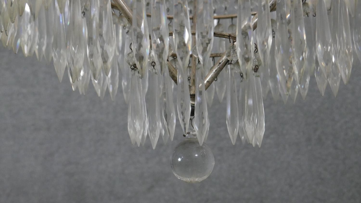 An early 20th century French silver plated crystal drop three tier waterfall chandelier, with four - Image 7 of 8