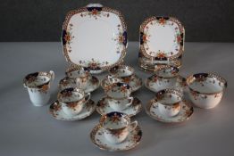 A Roslyn china seven person part tea set. Decorated with a floral design. Includes cups and saucers,