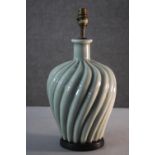 A vintage celadon glaze swirl design ceramic table lamp with brass fittings and ebonised base. H.