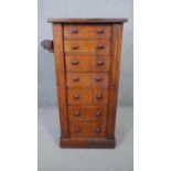 A Victorian walnut Wellington chest of seven drawers with locking stile fitted with candle slide and