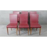A set of six contemporary high back dining chairs in faux leather upholstery.