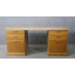 A contemporary light oak three section pedestal desk on plinth base. H.75 W.158 D.77cm