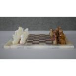 A vintage hand carved alabaster chess set with alabaster chess board. (Complete) H.1 W.30 D.30cm (
