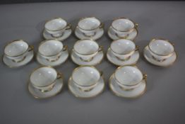 A set of eleven French Ulim Limoges gilded fine porcelain coffee cups and saucers. Makers mark to