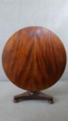 A 19th century figured mahogany tilt top dining table on triform platform base. H.74 Diam.120CM