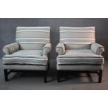 A pair of contemporary library armchairs in striped and piped upholstery on ebonised laquered and