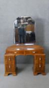 A mid century walnut Art Deco style dressing table with cloud shaped adjustable mirror above six