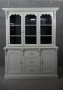 A distressed painted 19th century kitchen dresser with upper glazed section above an arrangement