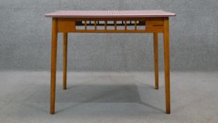 A vintage beech kitchen table with composite laminated gingham check top on shaped splay tapering