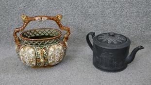 A 19th century Alhambrian majolica basket with branch handle along with a Basalt Wedgwood teapot