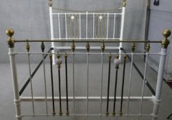 A Victorian brass and iron bedstead with porcelain mounts, to take a kingsize mattress.