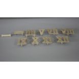 Ten painted cast iron Roman numeral door plates. H.9 W.12 D.3cm (largest)