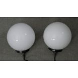 A pair of vintage style ceiling pendant lights with white opaque glass globe shades. H.23 W.19cm