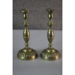 A pair of Victorian brass candlesticks with gadrooned detailing. H.30 Diameter 13cm.